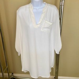 Ivory tunic with deep V and button detail on the sleeve